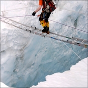 Crossing a crevasse in the Khumbu icefall